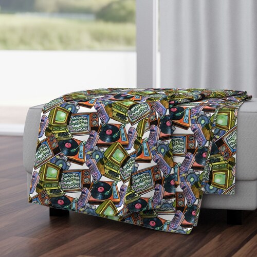 Living in the Plastic Age pattern shown on a throw blanket