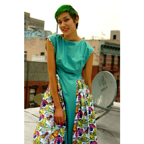 Wings fabric sewn into a dress, worn by a model on a rooftop